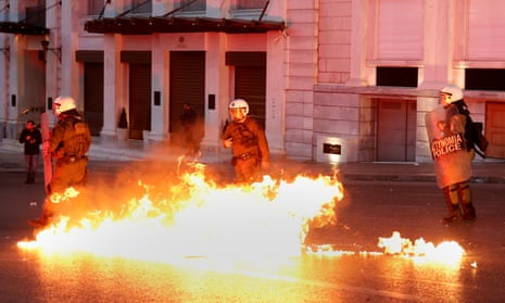 Greek riot police dodge a petrol bomb
