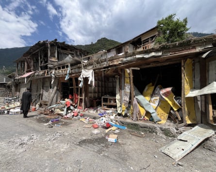 People clean up after an Indian attack in Neelum Valley in Pakistan-administered Kashmir on 10 May.