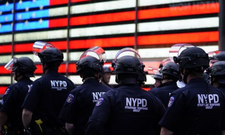 Police officers watch demonstrators in Times Square on 1 June 2020, during a Black Lives Matter protest. 