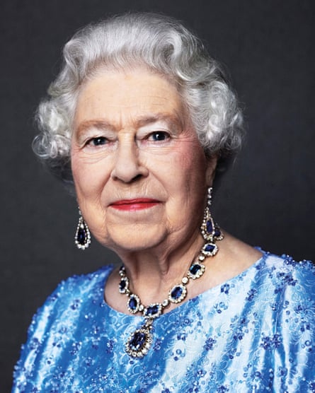 Queen Elizabeth II posing wearing a suite of sapphire jewellery given to her by King George VI as a wedding gift in 1947