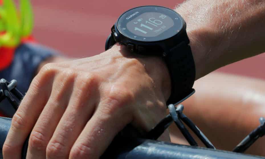 A runner wearing a Garmin smartwatch