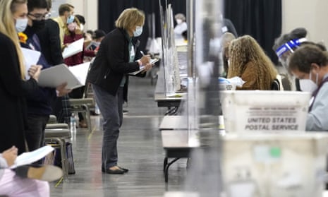 Recount observers watch ballots during a Milwaukee hand recount of Presidential votes at the Wisconsin Center, Nov. 20, 2020, in Milwaukee, Wis.