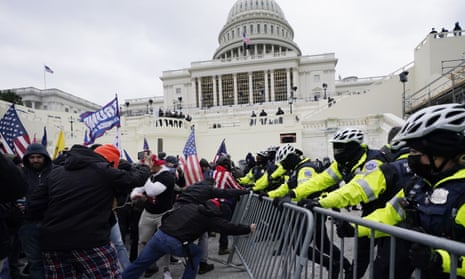 Trump supporters try to break through a police barrier at the Capitol on 6 January.