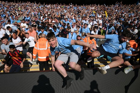 Fans of Manchester City invade the pitch.
