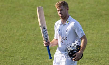 A sun dappled Ben Compton raises his bat