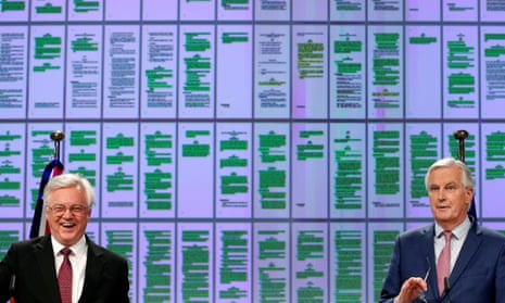 David Davis (left), the Brexit secretary, and Michel Barnier, the EU’s chief Brexit negotiator, at their news conference. On a screen behind them are projected pages from the colour-coded draft withdrawal agreement, with the green patches showing what has been agreed.
