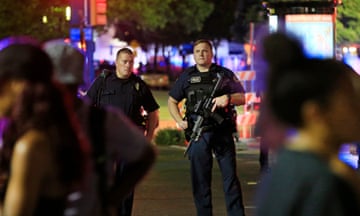 Four Police Officers Killed During Anti-Police Brutality March In Dallas<br>DALLAS, TX - JULY 7: Dallas police and residents stand near the scene where four Dallas police officers were shot and killed on July 7, 2016 in Dallas, Texas. According to reports, shots were fired during a protest being held in downtown Dallas in response to recent fatal shootings of two black men by police - Alton Sterling on July 5, 2016 in Baton Rouge, Louisiana and Philando Castile on July 6, 2016, in Falcon Heights, Minnesota. (Photo by Ron Jenkins/Getty Images)