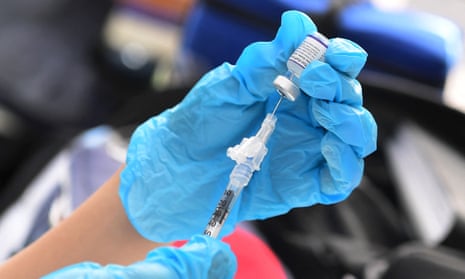 A shot of the Pfizer Covid-19 vaccine is prepared for administration at a vaccination clinic in Los Angeles.