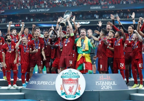Jordan Henderson lifts the trophy Liverpool celebrate winning the UEFA Super Cup.