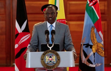 Ruto surrounded by flags at podium