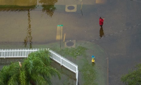 A man photographs floodwaters outside his residence in the aftermath of Hurricane Idalia in Tarpon Springs, Florida.