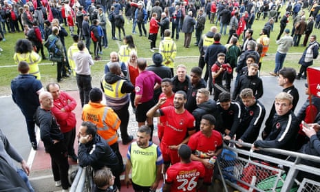 Leyton Orient players waiting in the tunnel while fans are on the pitch protesting during their game against Colchester. It was abandoned before later being finished.