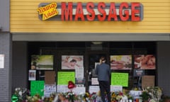 A person stands in front of a makeshift memorial outside Youngs Asian Massage in Acworth, Georgia, on 19 March. 