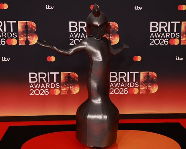 A model dressed as the Brit awards trophy arrives for the BRIT Awards at the Co-op Live Arena