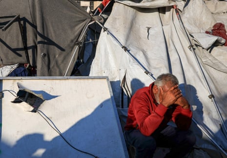 A Palestinian man reacts at the site of an overnight Israeli strike on a tent sheltering displaced people, in Gaza City, July 24, 2025.