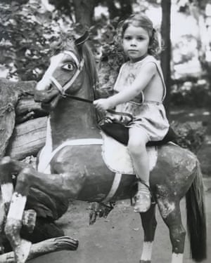 Children photographed on a toy horse in Tbilisi zoo by photographer Victor Sukiasov from the online archive zoophotography.ge