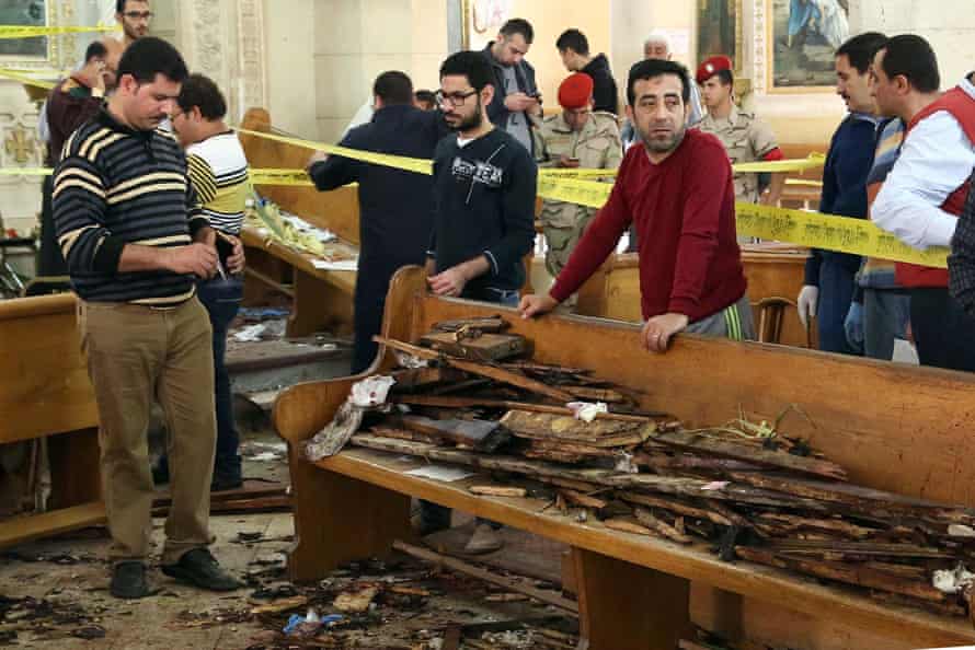 Forensic experts collect evidence at the site of a bomb blast that struck worshippers gathering to celebrate Palm Sunday at the Mar Girgis Coptic church in the Nile Delta City of Tanta, 75 miles north of Cairo.