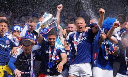 Ipswich captain Sam Morsy lifts the trophy as he, and his teammates, celebrate beating Huddersfield to clinch promotion.