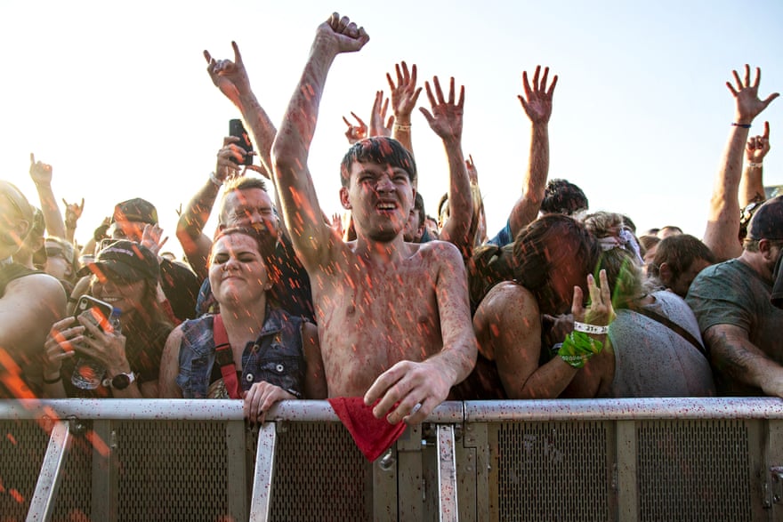 Festivalgoers covered with fake blood react as Gwar perform during Louder Than Life 2019 in Louisville, Kentucky.