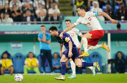 Argentina’s Lionel Messi shrugs off the challenge of Poland’s Robert Lewandowski.