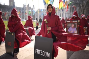 London, UKProtesters dressed as handmaids from The Handmaid’s Tale hold placards and flowers before a march from Parliament Square to the Iranian embassy to highlight the repression of women in Iran