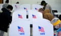 A row of voting booths at a US voting station in a gymnasium.