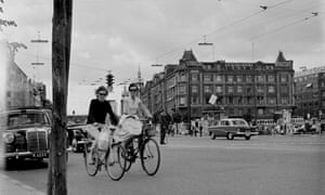 A street view of local girls riding their bicycles in Copenhagen, Denmark.