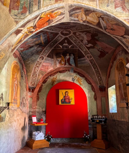 Medieval frescoes and a red door in a chapel