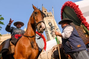 a man on a horse in front of a church
