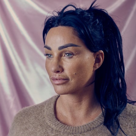 Headshot of model Katie Price in brown jumer against pink background
