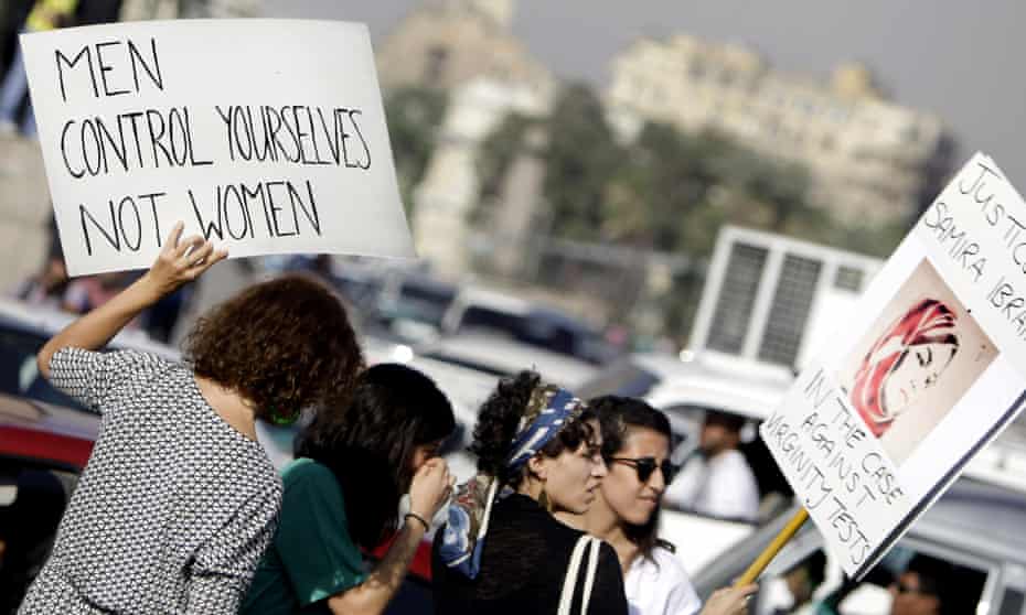 Women hold banners during a protest in the Egyptian capital Cairo against alleged sexual harassment by human rights lawyers