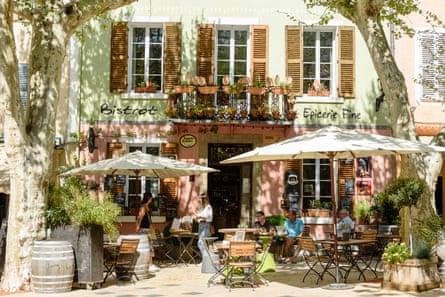 Exterior of a pastel coloured bistro with outdoor dining