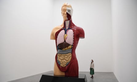 A gallery worker poses with artwork entitled ‘Hymn’, from 1999 by British artist Damien Hirst at the Newport Street Gallery.