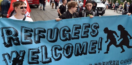 Participants in a demonstration in Frankfurt hold a banner reading “Refugees welcome.”