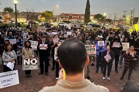 people hold signs against data centers