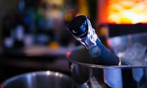 Champagne Bottle in Ice Cooler Beautiful Bar in the Background