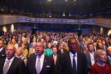 Conservative party members singing the national anthem.
