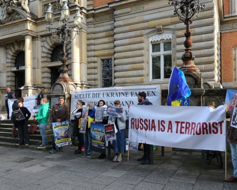 Ukraine supporters gather at the entrance to the Hanseatic Higher Regional Court in Hamburg, Germany.