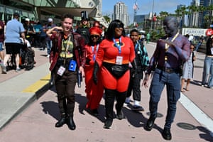 Fans walk outside the San Diego convention center, one wearing an Incredibles costume