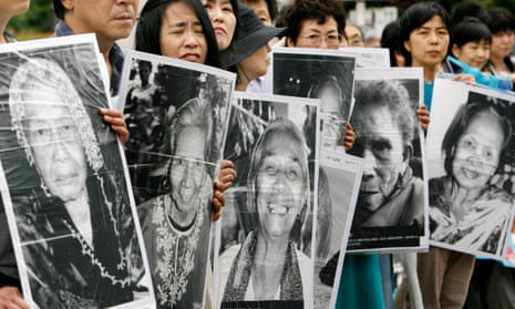 Japanese women hold portraits of former comfort women who were sex slaves for Japanese soldiers during the second world war, at a protest held in front of the Japanese parliament in 2007.