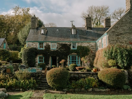 Carregfelen, a stone house clad in creepers in well tended gardens.