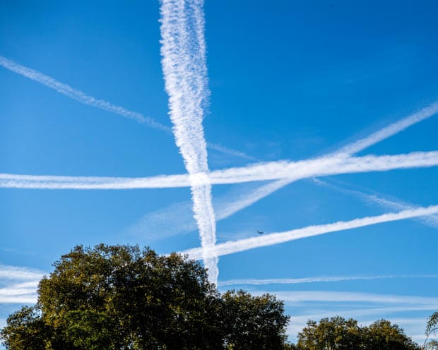Contrails or vapour trails above West London on a sunny October day.
