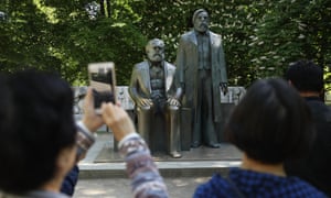 Visitors snap pics of statues of Marx (left) and Engels in a park in Berlin