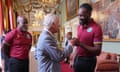 King Charles III fist bumps Mikyle Louis during his meeting with members of the West Indies men’s cricket team at Buckingham Palace.