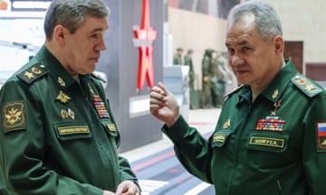 Sergei Shoigu, right, gestures while talking to Valery Gerasimov. Both men are dressed in military uniforms.
