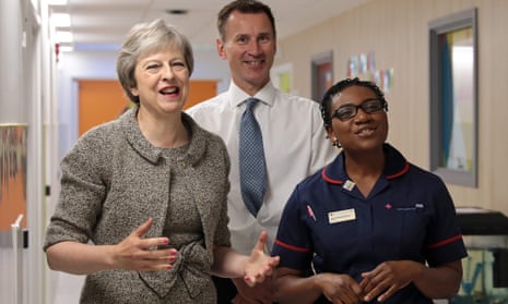 Theresa May (left) and Jeremy Hunt meet nursing staff during their visit to the Royal Free Hospital in London this morning.