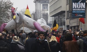Covid live: UK reports 82,886 new cases in huge weekly jump; Omicron dominant in Ireland 5 Protestors carry a giant unicorn during a demonstration against Covid-19 measures in Brussels on Sunday