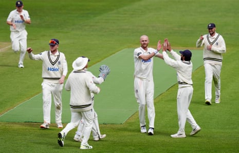Olly Hannon-Dalby is congratulated on taking a wicket by teammates