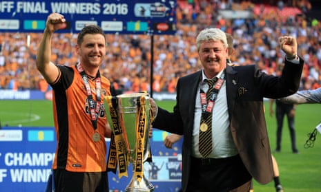 Alex Bruce celebrates Hull’s promotion to the Premier League with his dad, Steve, in 2016.