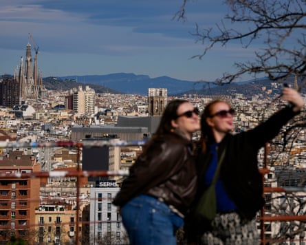 Two women take a selfie with the church in the background